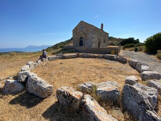 Traditional Threshing place in front of church, rocks and sea in Polyrinia on Crete