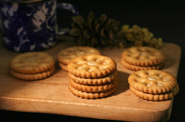Delicious sweet chocolate cookies on a wooden table with low light