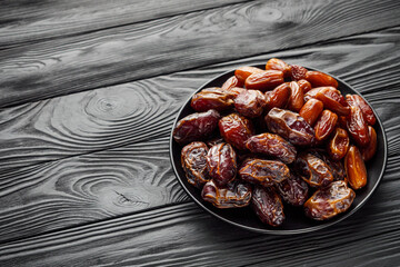 juicy royal dates on a black wooden rustic background