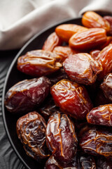 juicy royal dates on a black wooden rustic background