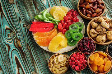 set of various dried fruits on a wooden rustic background