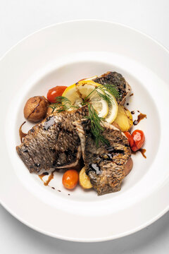 seared fresh sea bass fillet meal with potato and vegetables
