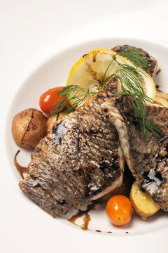 seared fresh sea bass fillet meal with potato and vegetables