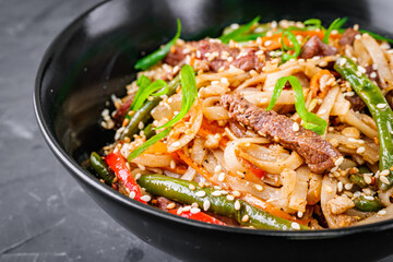 delicious chinese fried noodles on a black background