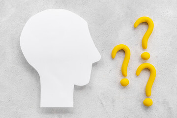 Question mark sign with paper human head. FAQ and help concept