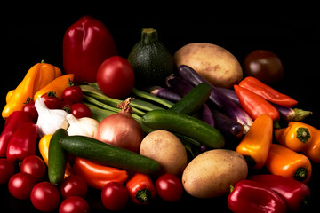 Variety of juicy vegetables on a black background