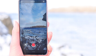 Smartphone in the hand winter mobile shooting . High quality photo