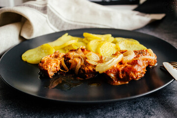 Meat with potatoes on a plate. Delicious hot dish