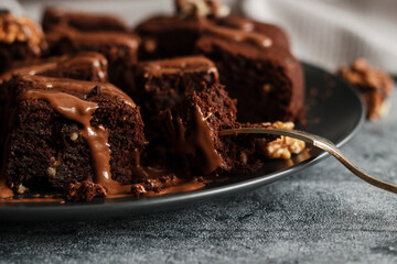 Tasty chocolate brownie. Pieces of cake on the table