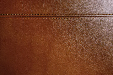 Natural, artificial brown leather texture background with decorative seam. Material for sport...