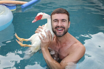 Man and his cute duck pet on vacations together