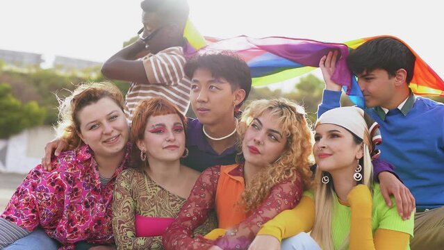 Group of happy young people having fun together during LGBT pride parade
