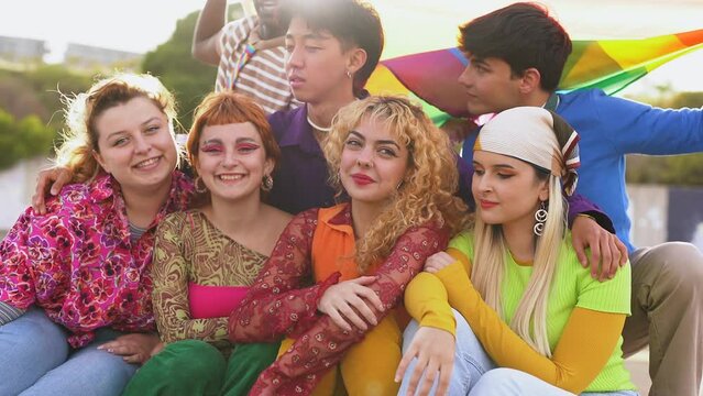 Young multiracial people celebrating together at LGBT pride parade	

