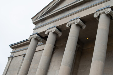 The exterior of a large courthouse with columns and pillars at the colonnade at the facade of the...