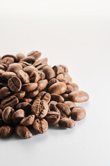 Roasted coffee beans isolated close up on white background, clipping path