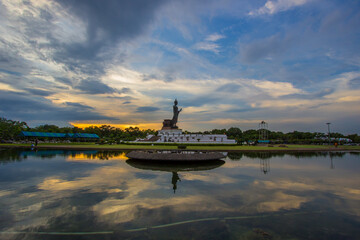 Fototapeta na wymiar sunset sky and Buddha statue at Phutthamonthon(Buddhist park in Nakhon Pathom Province of Thailand)