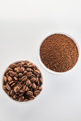 Roasted coffee whole and ground beans in bowl isolated close up on white background
