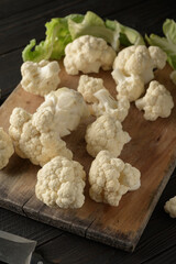 Raw, fresh organic cauliflower on a wooden background. Healthy eating, low carb diet concept