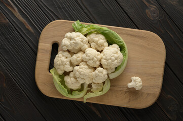 Raw, fresh organic cauliflower on a wooden background. Healthy eating, low carb diet concept