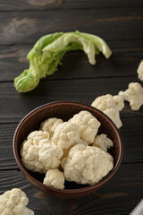 Raw, fresh organic cauliflower on a wooden background. Healthy eating, low carb diet concept