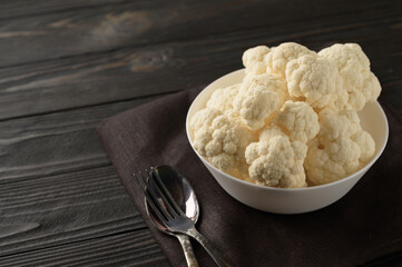 Raw, fresh organic cauliflower on a wooden background. Healthy eating, low carb diet concept