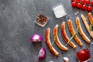 grilled sausages on a stone background with copy space for your text