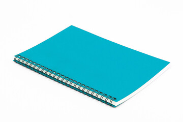 Spiral notebook with blue cover on white background