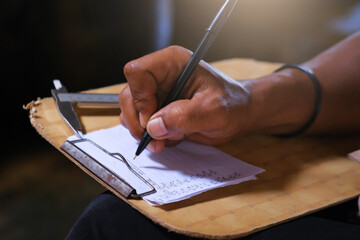close up of someone writing on a document