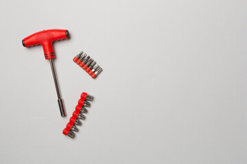 Screwdriver bit set on color background, top view
