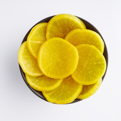takuan traditional japanese marinated daikon radish on a white background