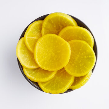 takuan traditional japanese marinated daikon radish on a white background