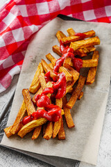golden french fries on a white wooden rustic background
