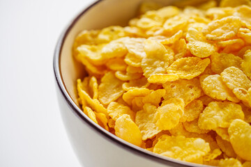 crispy golden cornflakes on a white acrylic background