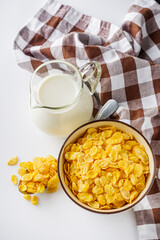 crispy golden cornflakes on a white acrylic background