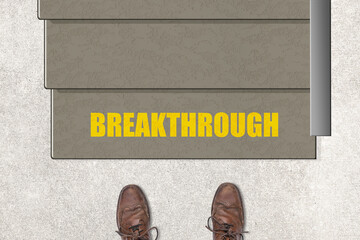 Motivational concept with the word Breakthrough on the first step of a staircase.