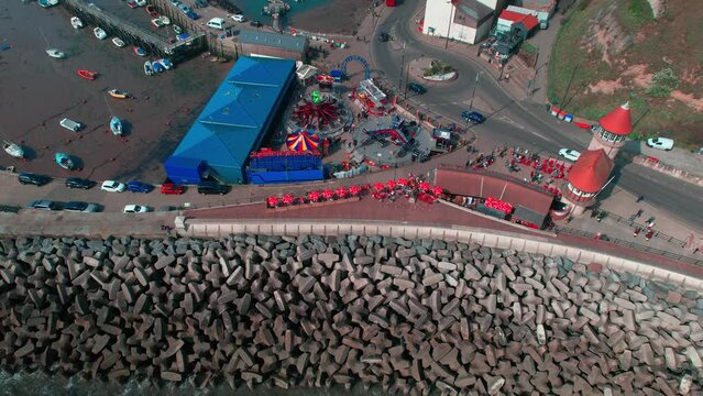 Aerial shot of street and rocks of sea with piegon bath corner in Scarborough UK. Pigeon Bath Corner in Scarborough pictured under a blue sky. 