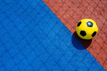 Colorful sports court background. Top view light blue field rubber ground with shadow from football...