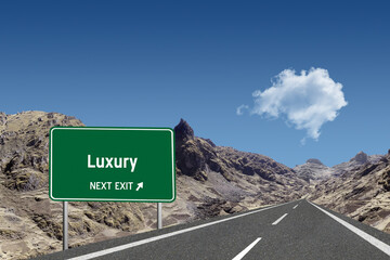 Highway sign with the word Luxury and a metaphoric road leading to future success.