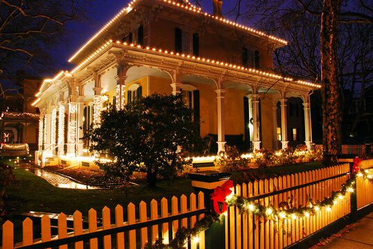 Christmas Lights And Holly Decorate A Victorian Home With Beautiful Columns And Architecture In Cape May New Jersey