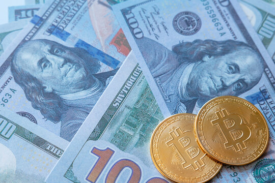 Cryptocurrency and real money concept photo. bitcoins on the us dollars