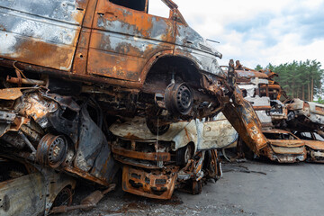 Fototapeta premium War in Ukraine. Car graveyard in Irpin. Shot cars of civilians.