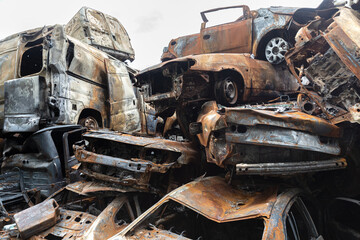 War in Ukraine. Car graveyard in Irpin. Shot cars of civilians.