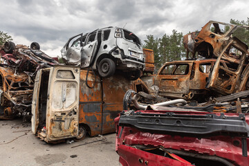 Fototapeta premium War in Ukraine. Car graveyard in Irpin. Shot cars of civilians.
