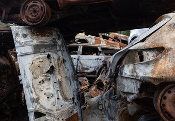 Fototapeta premium War in Ukraine. Car graveyard in Irpin. Shot cars of civilians.