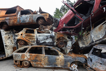 Fototapeta premium War in Ukraine. Car graveyard in Irpin. Shot cars of civilians.