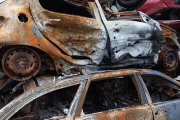 War in Ukraine. Car graveyard in Irpin. Shot cars of civilians.