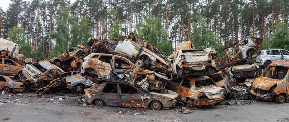 War in Ukraine. Car graveyard in Irpin. Shot cars of civilians.