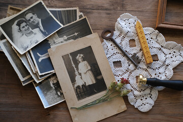 old family photos, pictures from 1940 in sepia color on wooden table, home archive documents, key,...