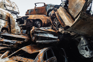 War in Ukraine. Car graveyard in Irpin. Shot cars of civilians.
