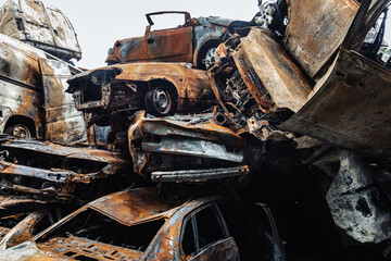 Fototapeta premium War in Ukraine. Car graveyard in Irpin. Shot cars of civilians.